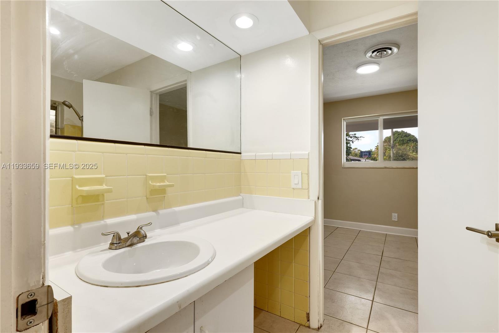 142 Southwest 53rd Avenue Plantation, FL 33317 - Photo 20 of 30 a bathroom with a sink and a mirror