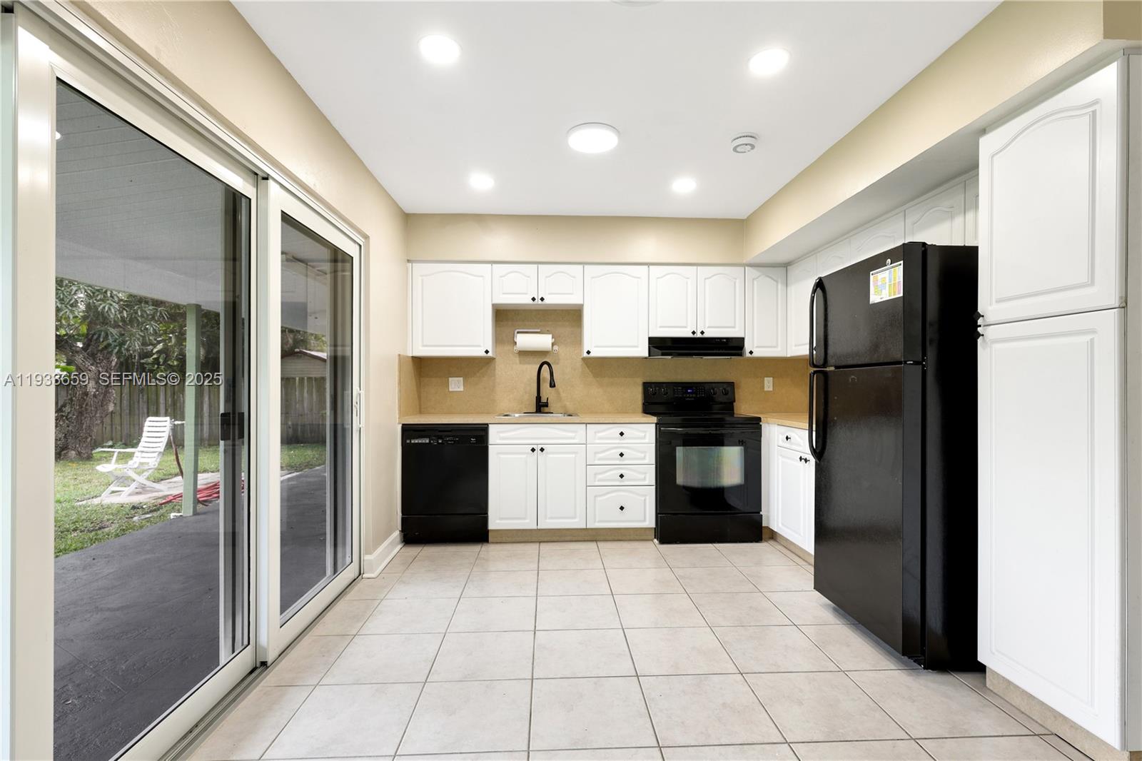 142 Southwest 53rd Avenue Plantation, FL 33317 - Photo 10 of 30 a kitchen with a refrigerator and a stove