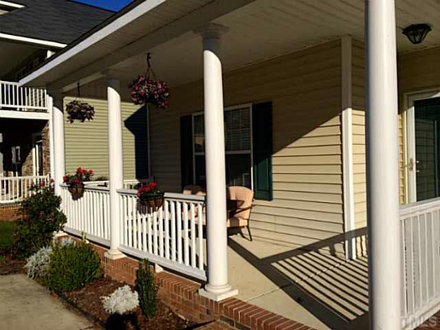 5833 Wynmore Road Raleigh, NC 27610 - Photo 22 of 24 a view of a porch with a bench