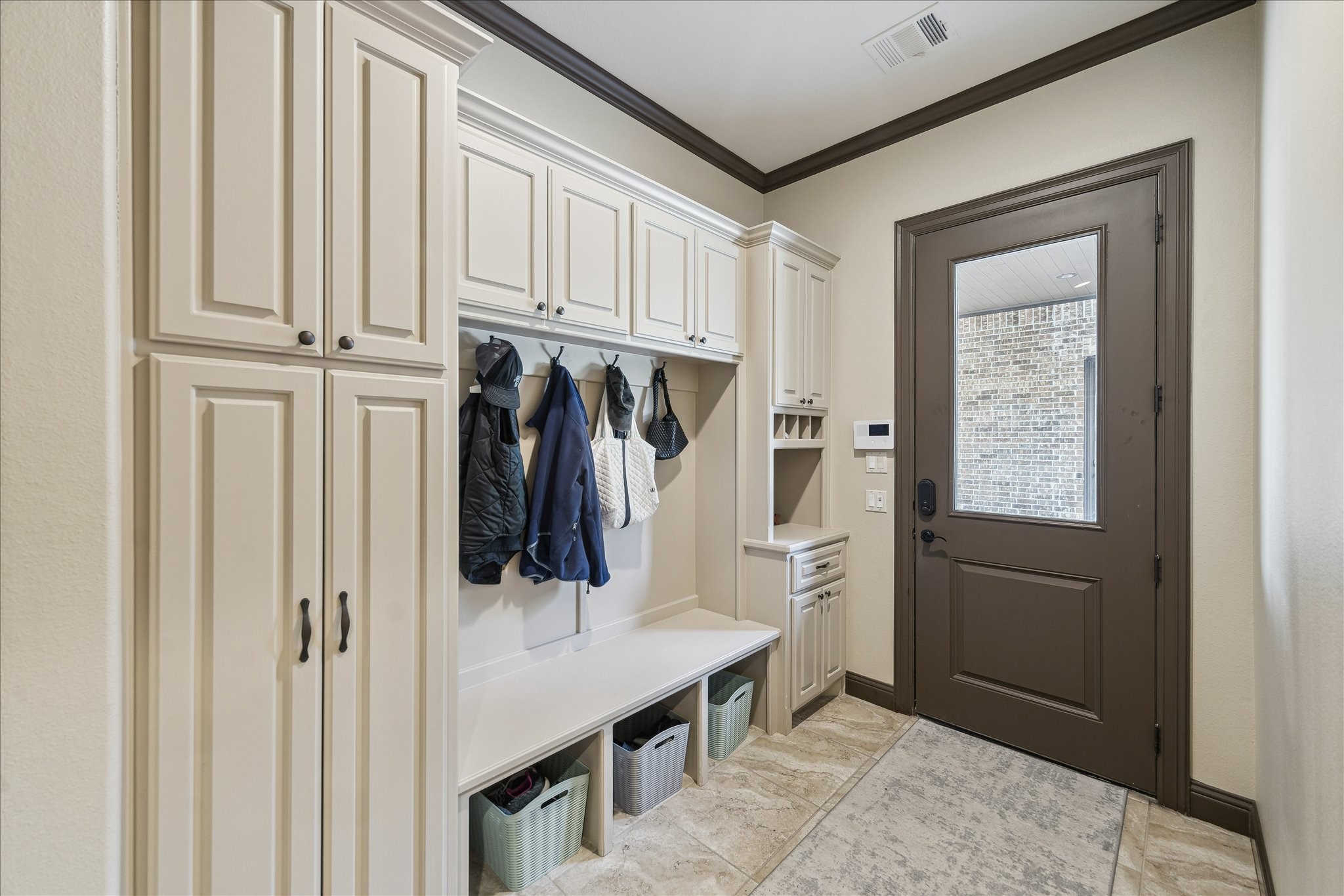 11 Willowcreek Ranch Road Tomball, TX 77377 - Photo 32 of 49 The mudroom provides access to the porte-cochere, motor court and garage. It features cabinetry for storage and organization.