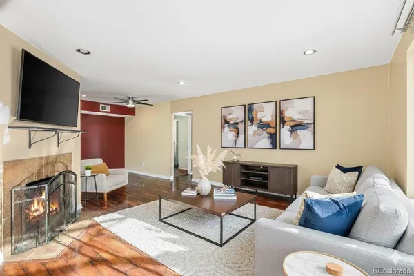 a living room with furniture a flat screen tv and a fireplace