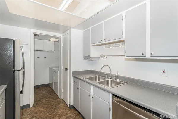 a kitchen with a sink and refrigerator