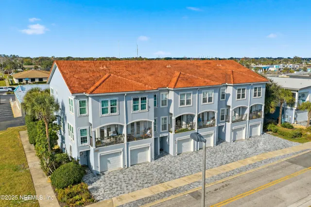 aerial view of a house with a ocean view