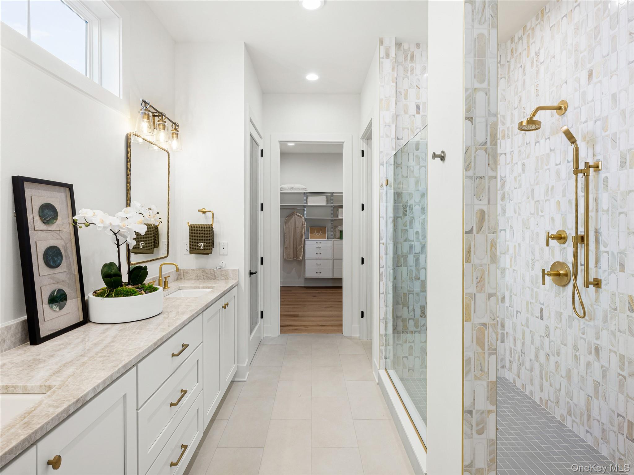 2027 Summit Loop, Unit 87 Carmel, NY 10512 - Photo 11 of 20 a bathroom with a double vanity sink a mirror a shower and vanity