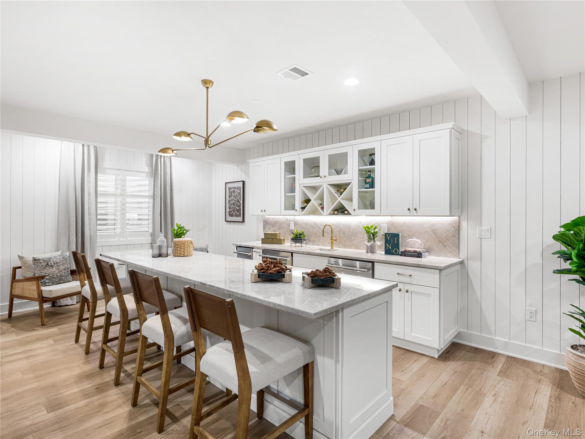 2027 Summit Loop, Unit 87 Carmel, NY 10512 - Photo 4 of 20 a kitchen with a dining table chairs sink and white cabinets