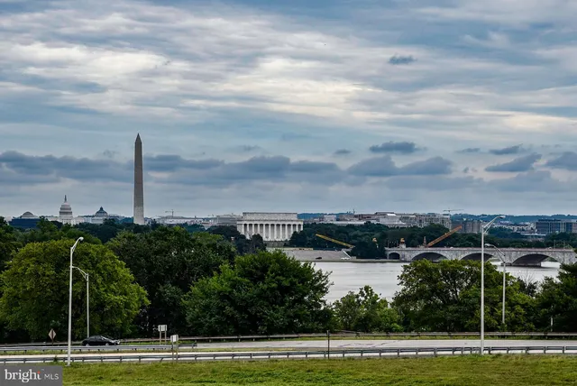 a view of a patio with table and chairs under an umbrella