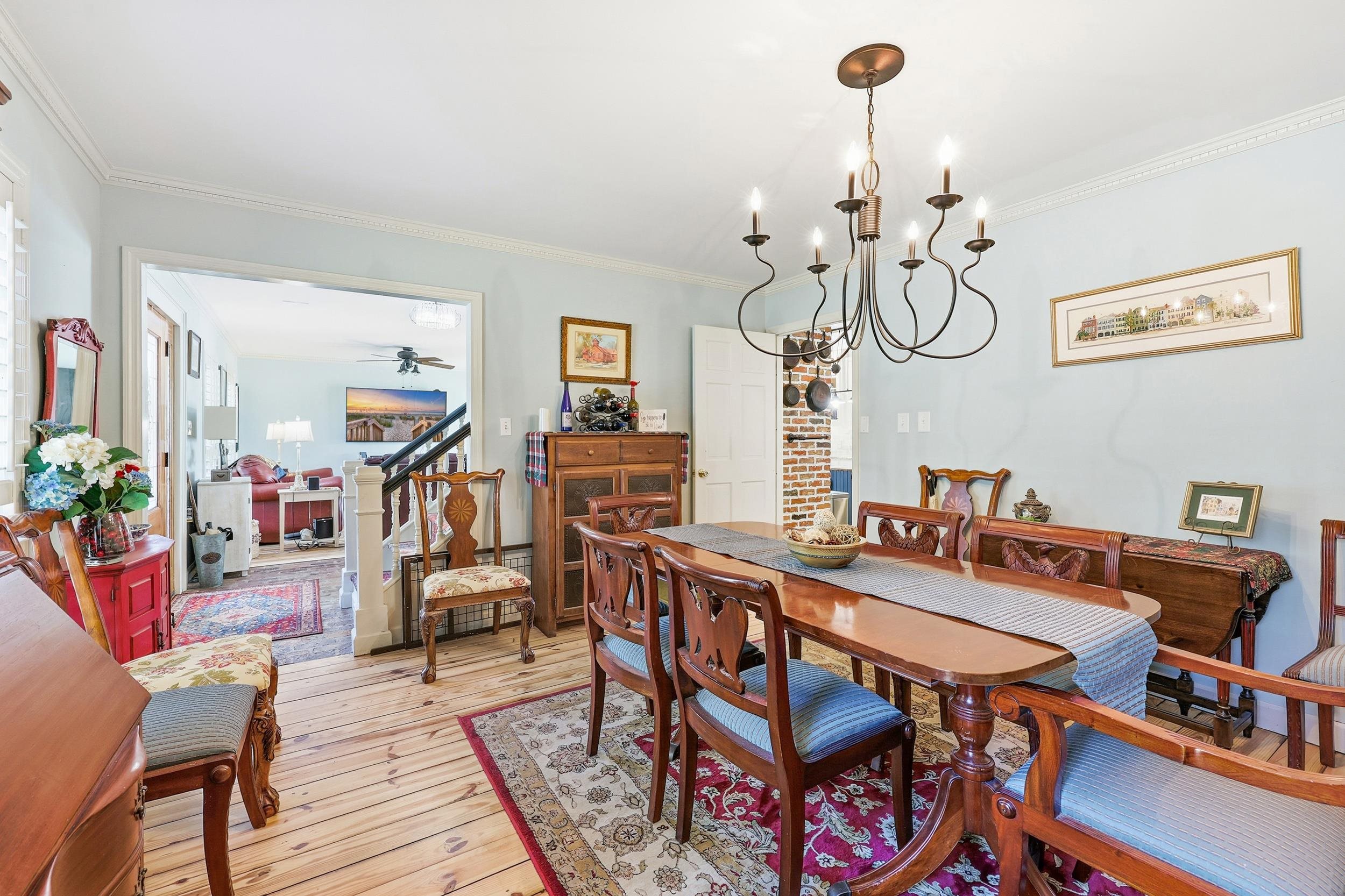 709 Mt Gilead Road Murrells Inlet, SC 29576 - Photo 13 of 38 Dining space featuring light wood-type flooring, a chandelier, ornamental molding, and a ceiling fan