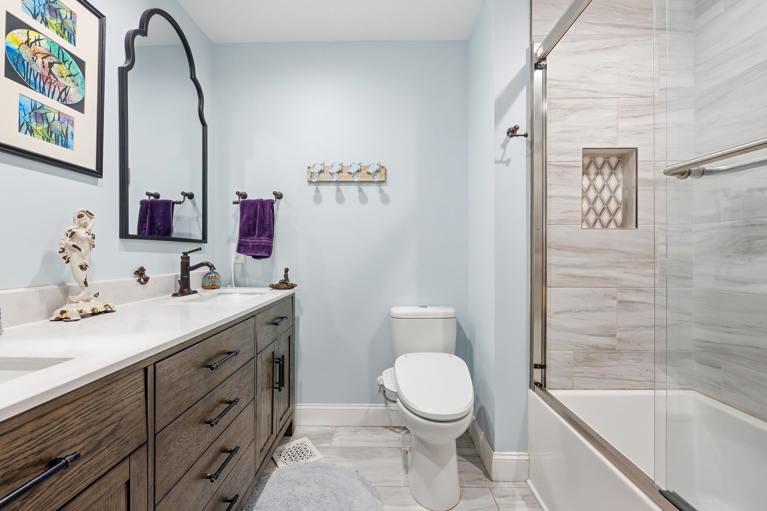 709 Mt Gilead Road Murrells Inlet, SC 29576 - Photo 18 of 38 Bathroom featuring double vanity and bath / shower combo with glass door