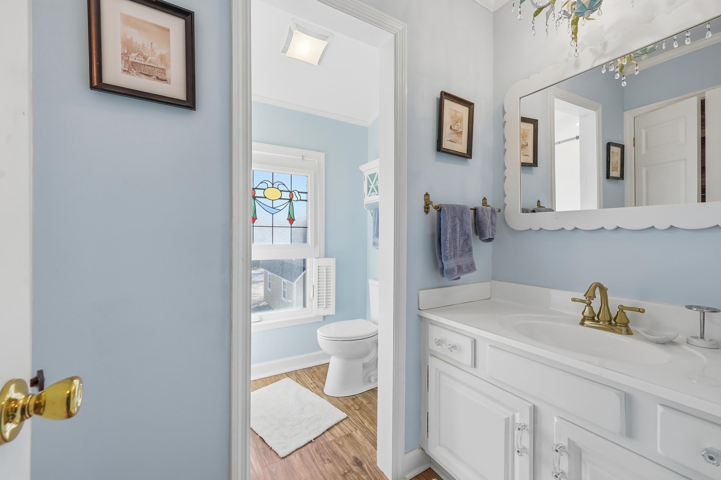 709 Mt Gilead Road Murrells Inlet, SC 29576 - Photo 22 of 38 Bathroom featuring crown molding, vanity, and light wood-type flooring