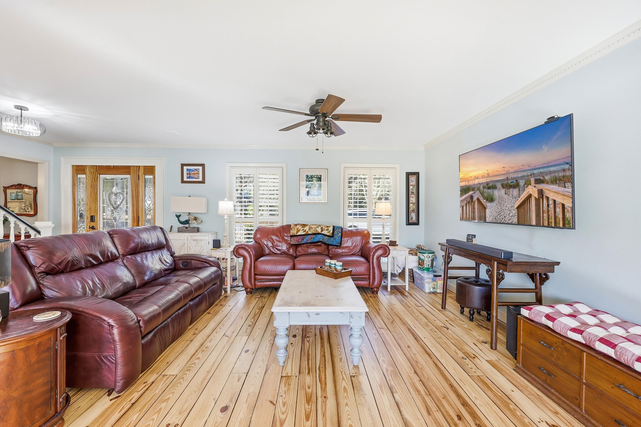 709 Mt Gilead Road Murrells Inlet, SC 29576 - Photo 4 of 38 Living room featuring light wood finished floors, a ceiling fan, ornamental molding, and stairway