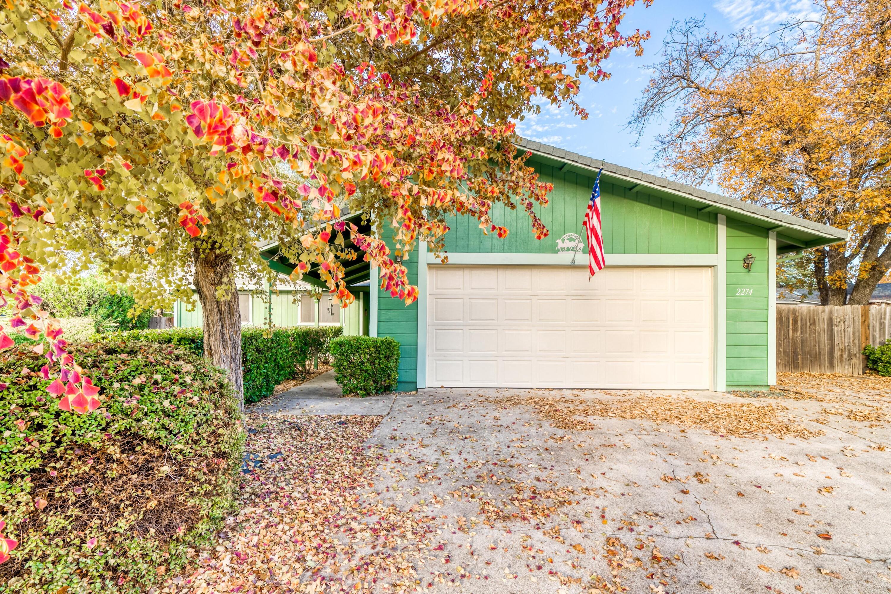 2274 Jessica Way Redding, CA 96002 - Photo 17 of 18 a view of a house with a small yard and a large tree