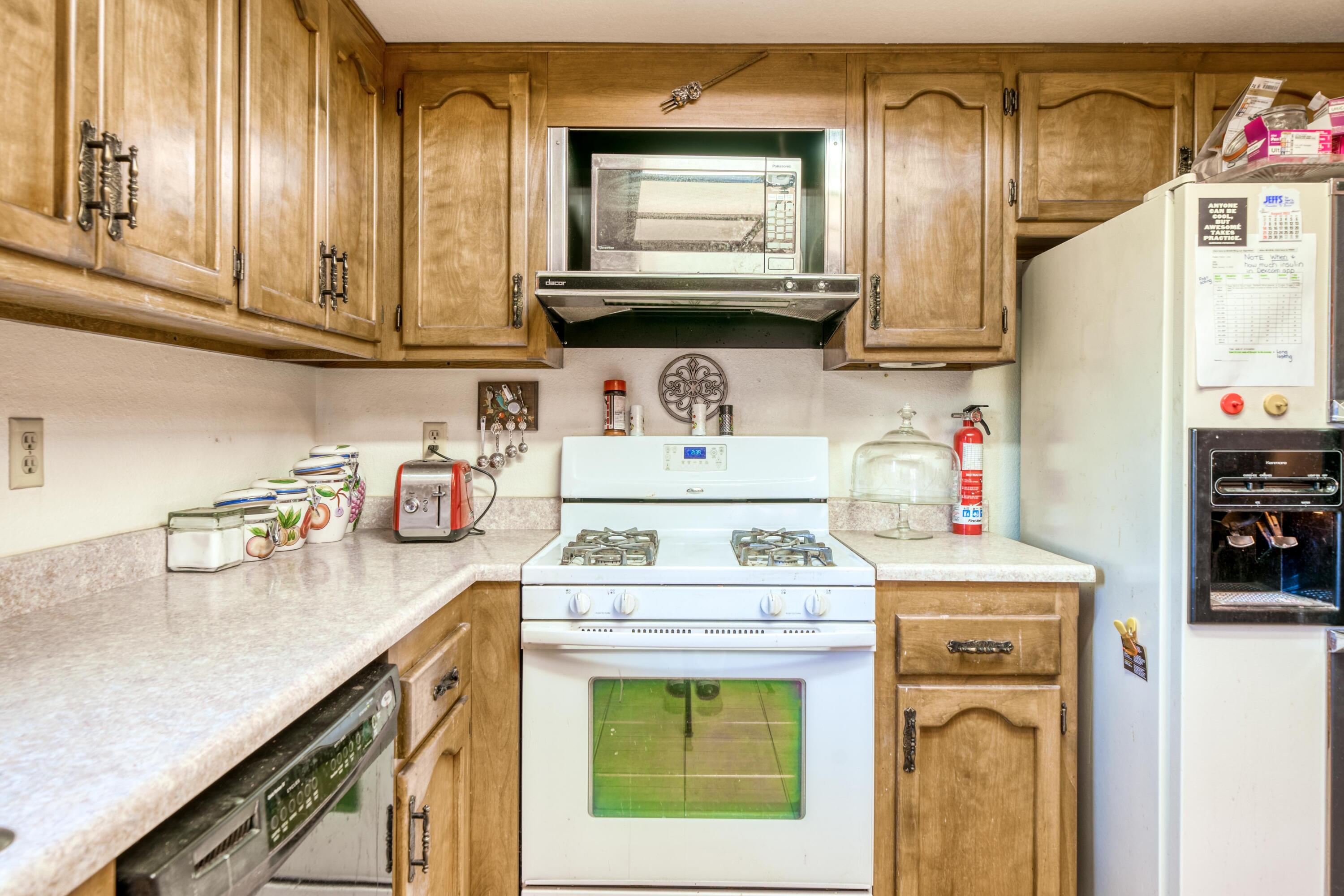 2274 Jessica Way Redding, CA 96002 - Photo 5 of 18 a kitchen with a stove and a microwave