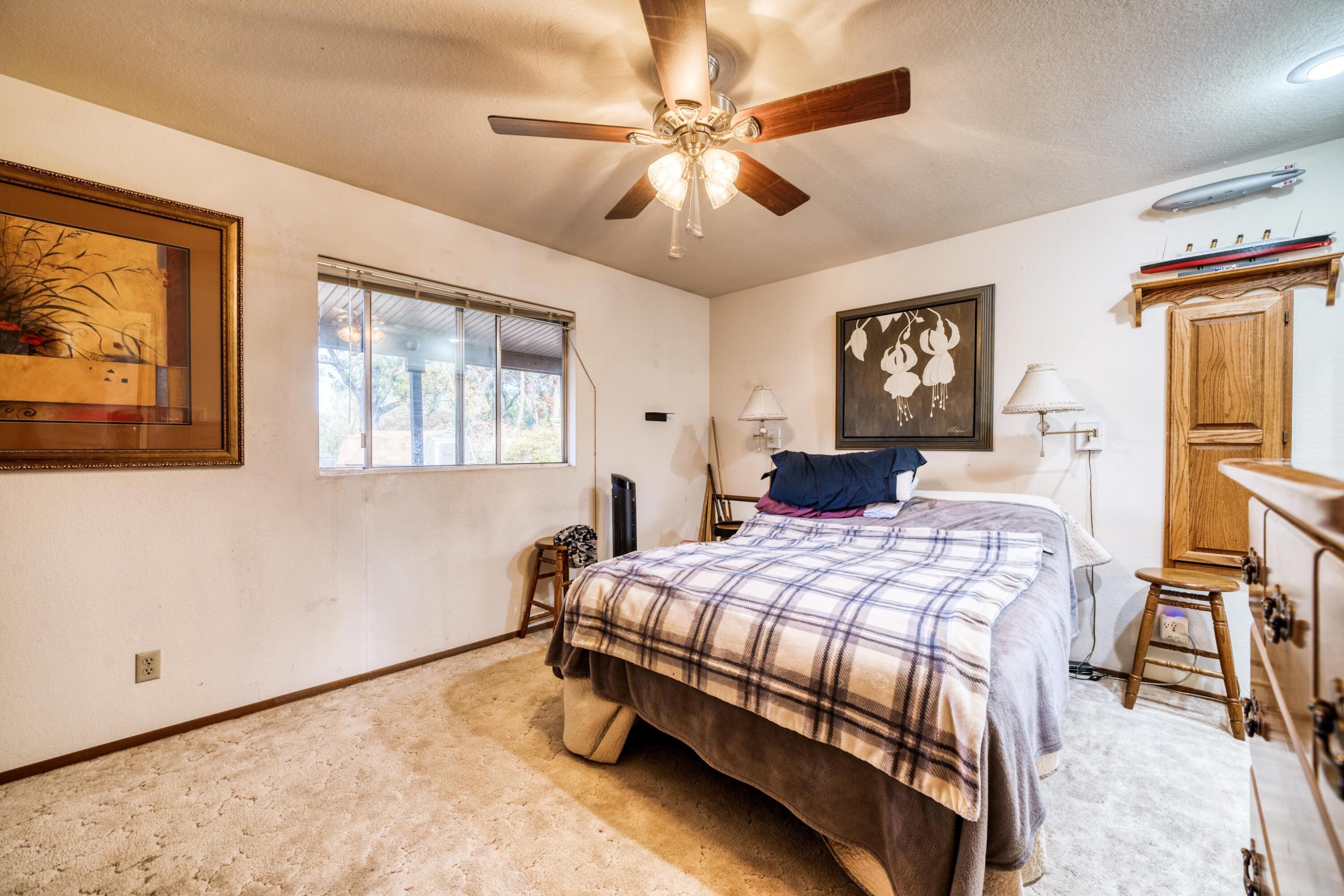 2274 Jessica Way Redding, CA 96002 - Photo 10 of 18 a bedroom with a bed and a chandelier