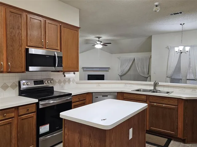 a view of a room with wooden floor and a ceiling fan
