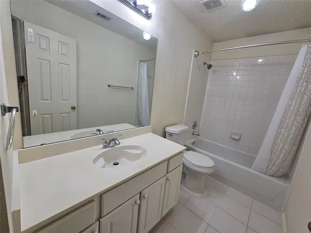 a bathroom with a double vanity sink toilet mirror and shower