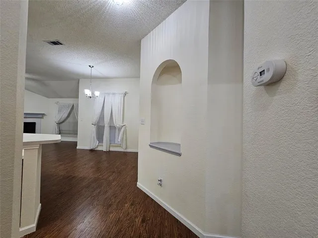 a view of a kitchen with wooden floor and a sink