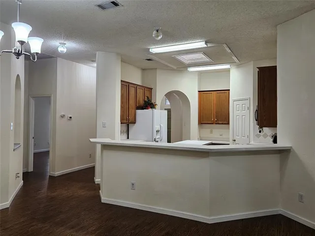 a kitchen with a sink stove and microwave