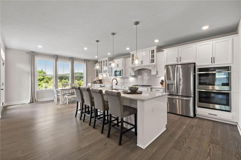 313 Crest Lane Mars, PA 16046 - Photo 13 of 50 a kitchen with a table chairs refrigerator and microwave