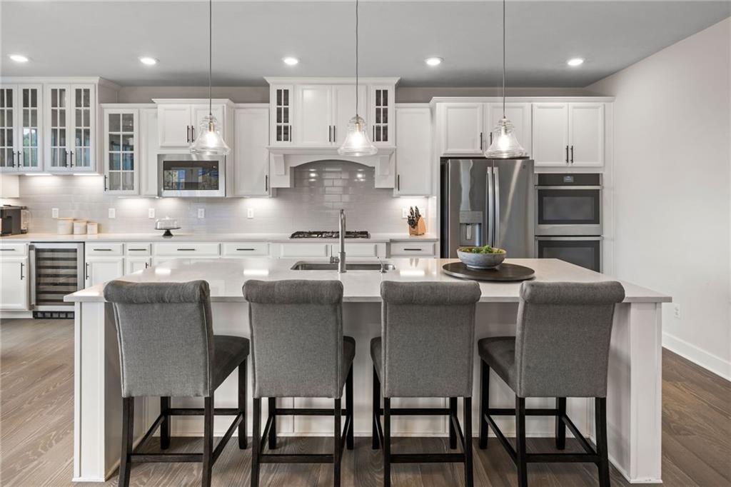 313 Crest Lane Mars, PA 16046 - Photo 16 of 50 a kitchen with stainless steel appliances granite countertop a dining table chairs refrigerator and microwave
