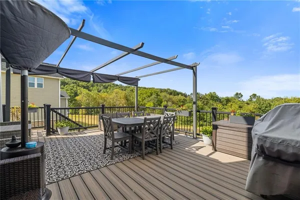 a view of outdoor dining space with furniture and wooden floor