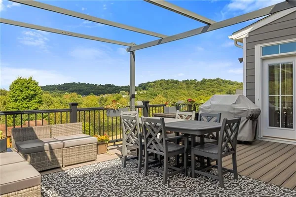a view of a balcony dining table and chairs