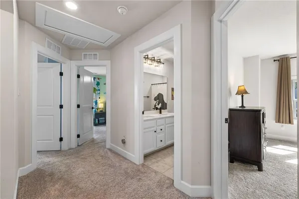a view of a hallway to closet and mirror