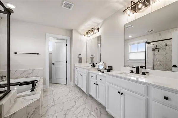 a bathroom with a double vanity sink mirror and