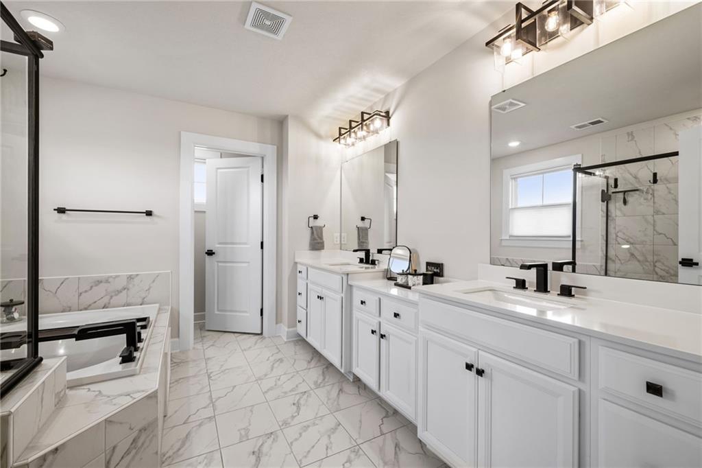 313 Crest Lane Mars, PA 16046 - Photo 33 of 50 a bathroom with a double vanity sink a mirror and a shower