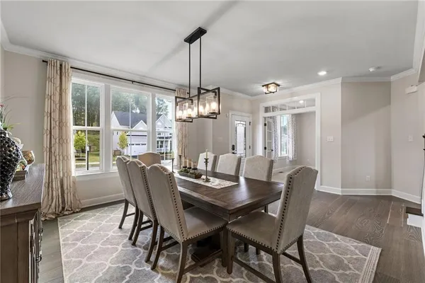 a view of a dining room with furniture window and wooden floor