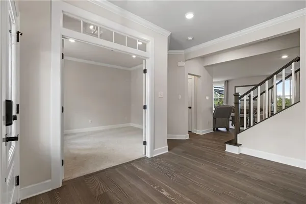 a view of a hallway with wooden floor and entryway