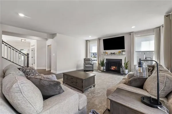 a living room with furniture a flat screen tv and a fireplace
