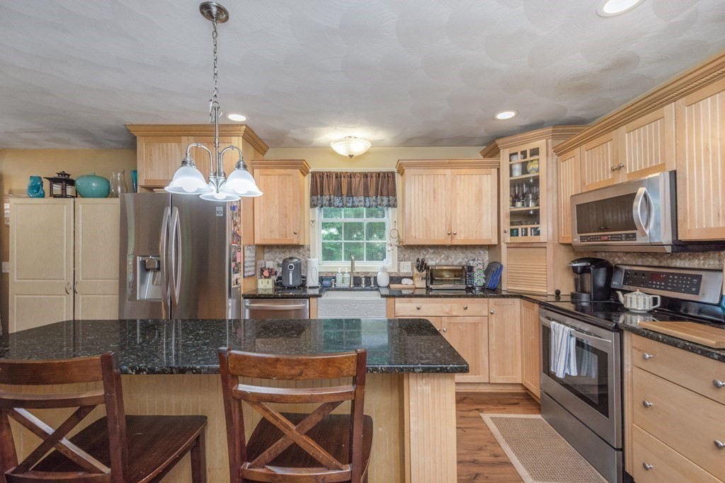 132 Fowler Road Northbridge, MA 01534 - Photo 16 of 42 a kitchen with sink a refrigerator and chairs