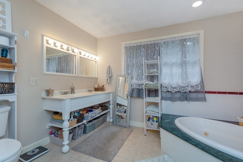 132 Fowler Road Northbridge, MA 01534 - Photo 27 of 42 a bathroom with a tub a sink and a mirror