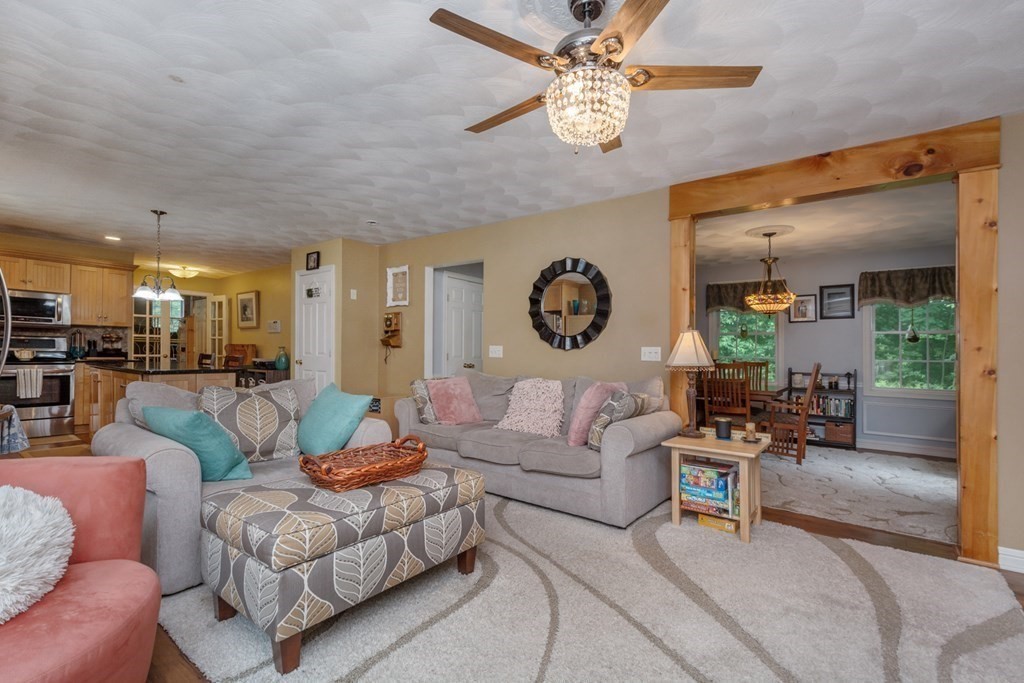 132 Fowler Road Northbridge, MA 01534 - Photo 8 of 42 a living room with furniture kitchen view and a chandelier