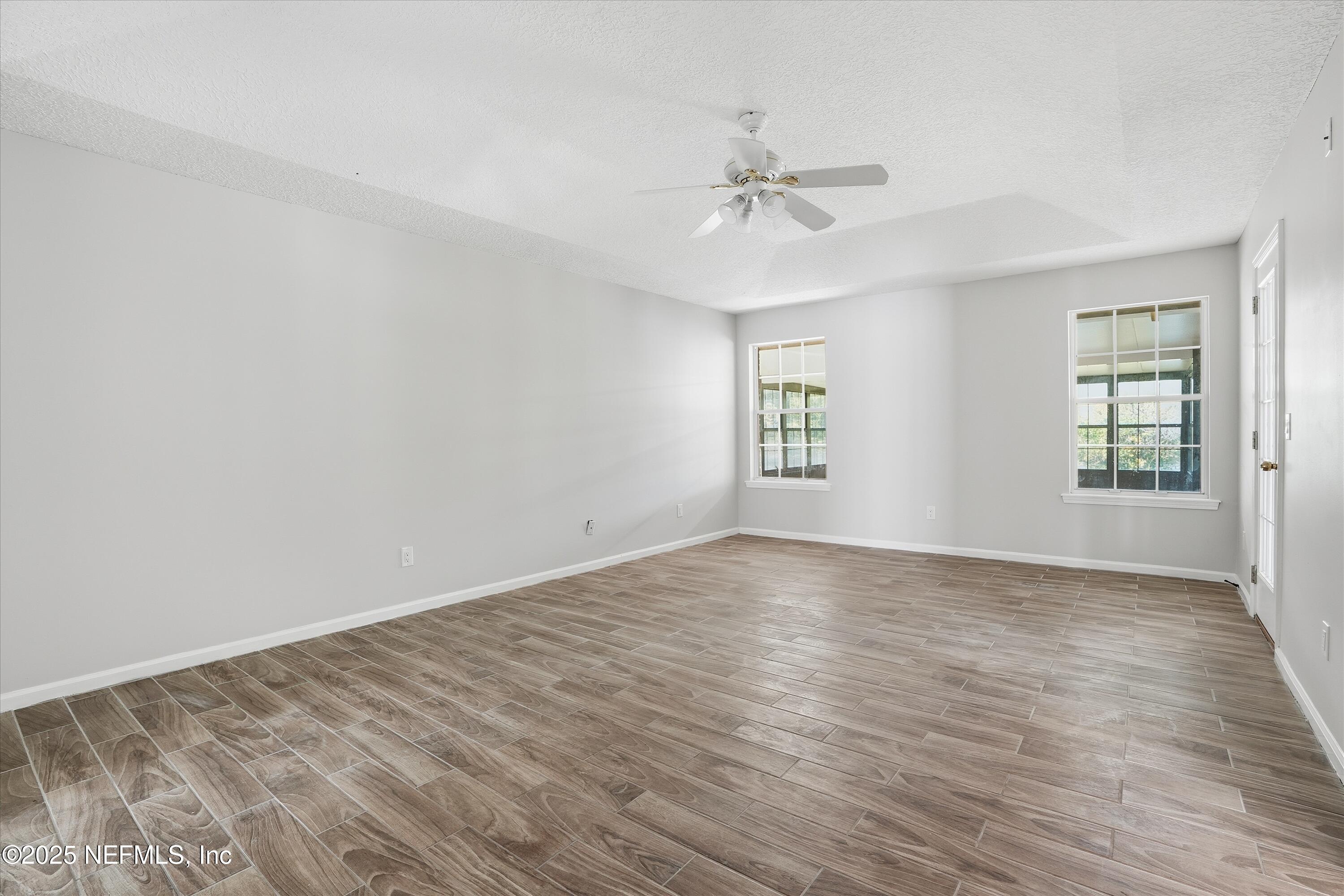 1634 Dockside Drive Fleming Island, FL 32003 - Photo 17 of 39 wooden floor in an empty room with a window