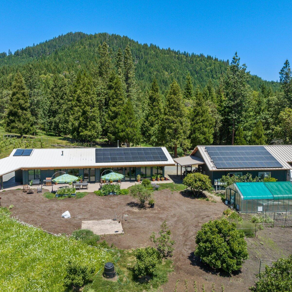 an aerial view of a house with garden space and street view