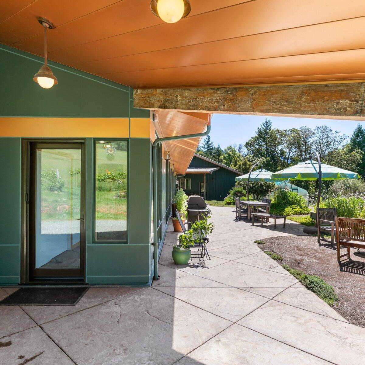 1104 Upper Cow Creek Road Azalea, OR 97410 - Photo 4 of 77 a view of a patio with a table and chairs under an umbrella