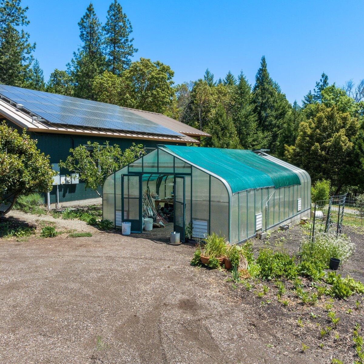 1104 Upper Cow Creek Road Azalea, OR 97410 - Photo 47 of 77 a view of a barn with a table and chairs under an umbrella