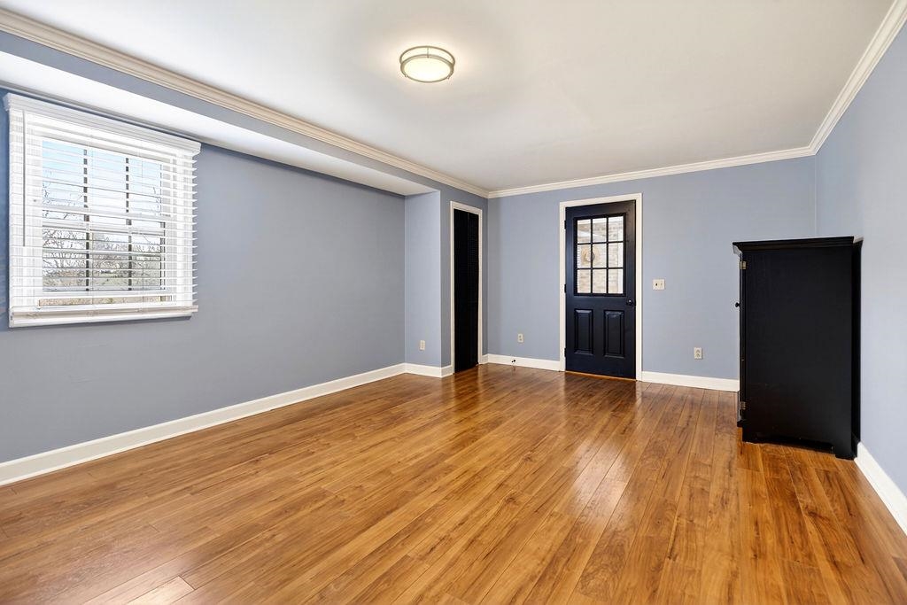224 Meadowbrook Road Staunton, VA 24401 - Photo 41 of 59 a view of an empty room with wooden floor and a window