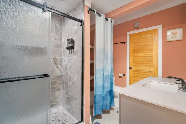 a bedroom with a bed and a painting on the wall