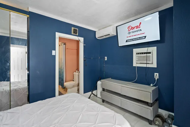 a living room with furniture flat screen tv and wooden floor