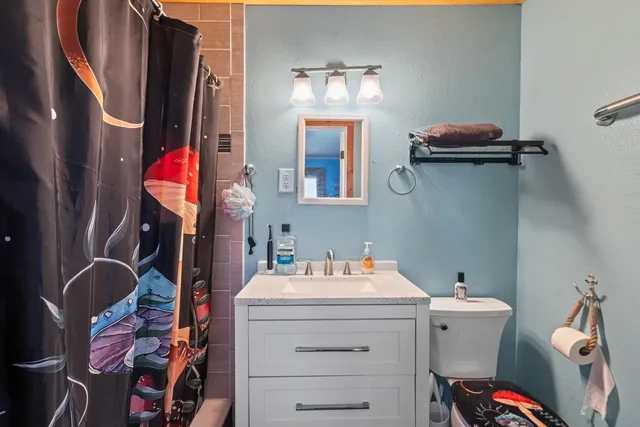 a view of a house with yard and lake view