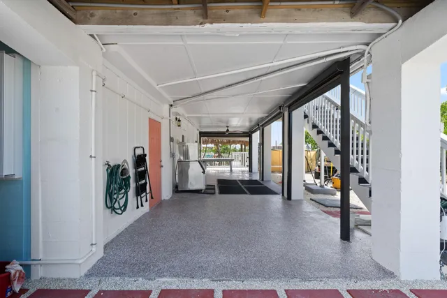 a view of a hallway with closet and mirror