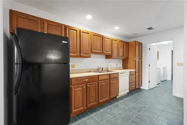 a kitchen with stainless steel appliances granite countertop a stove and a sink