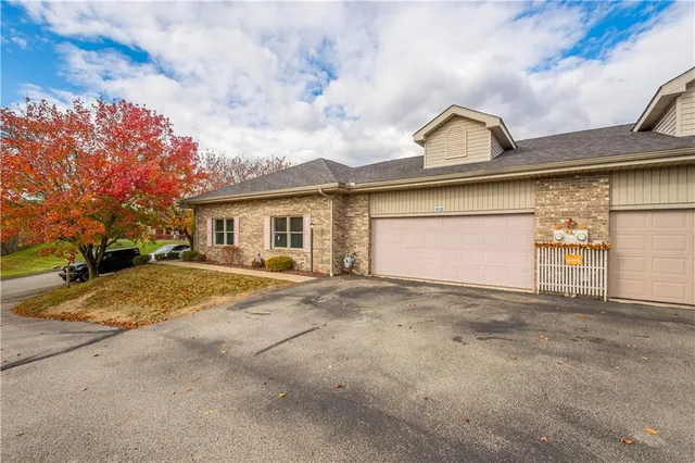 a view of a house with a outdoor space and garage