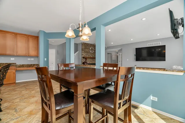 a view of a dining room with furniture and a chandelier