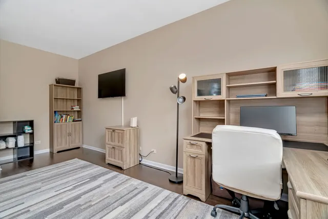 a room with a chair and flat screen tv