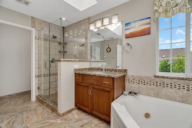 a bathroom with a tub a sink and a shower