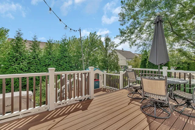 a view of deck with a table and chairs