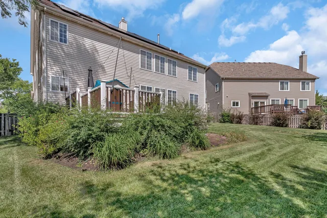 a backyard of a house with table and chairs